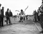 Jimmy Crawley of Midwestern University, action broad jump by Al Panzera
