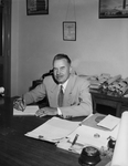 C. Milo Thelin, shown at desk