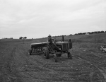 L. T. Cathcart is sowing vetch and Mustang oats on his farm in Dalworth