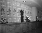 Dr. William Crawford shown speaking on auditorium stage at the academy
