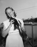 Mrs. B. B. Daly with pet skunk