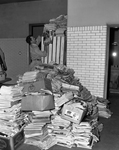 Fireman Jeff Waters, shown with stacks of papers