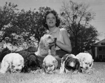 Martha High shown with litter of cocker spaniel puppies