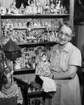 Mrs. Mary Clarke with her doll collection.
