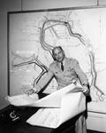 Col. Harry O. Fischer studying flood control and water conservation plans