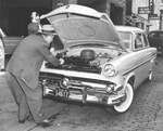 Detective Sergeant John Dunwoody checks engine of "mystery car" in David F. Hagler Jr. case