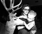 Elliott Louis McLanahan examines a reindeer head at Christmas party for blind children