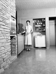 Mrs. Stanley standing in the kitchen in the family residence, Fort Worth, Texas