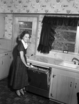 Mrs. Max W. Martin in the kitchen of the family residence, 5628 Blueridge Drive, Fort Worth, Texas