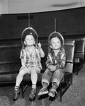 Alan Hague and Tim Gauss wearing space helmets at Planetarium by Wilburn Davis