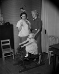 Linda Key, age 4, has her hearing aid checked at the Crippled Children's Society