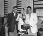 John Jay Hopkins giving trophy to Cary Middlecoff with Al Balding looking on