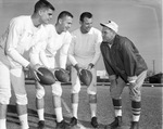 Coach Abe Martin talks with three Texas Christian University (T. C. U.) quarterbacks before Cotton Bowl game with Syracuse University by Al Panzera
