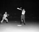 Mayor Tommy Vandergriff swings at pitch thrown by Sheriff Harlon Wright at the start of American Legion's junior baseball game at La Grave Field by Al Panzera