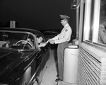 First Dallas-Fort Worth Turnpike customer Billy John Keeter in automobile being given a toll road ticket by K. W. Mulanax