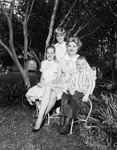 Mrs. Guy Rogers Jr., pictured in the garden of her home, with her children