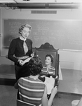 Am. Airlines Stewardess College. . . Kelly Flint, left, with Marilyn T. Kennedy showing beauty counseling