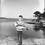 Bram Lasseter holding bass caught in Possum Kingdom age 5 1/2 son of W.L. Lasseter.