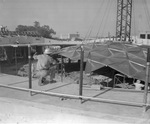 Workmen installing aluminum dome during construction of Casa Manana