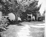 In the patio of the Richard C. Newkirk home, are Mrs. Thomas J. Reed, Mrs. Newkirk, and Mrs. Edwin H. Jackson