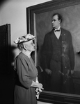 Margaret McLean looking at portrait of her brother, Jefferson D. McLean