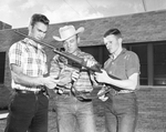 Adult leader Ken Coffman explains use of the rifle sling to team members Clayton Flanagan and Gary Ken Coffman by Bee Landrum