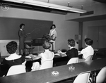 Girls attending the American Airlines Stewardess College, near Carter Field, learn to identify the parts of planes in which they later will serve as stewardesses
