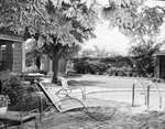 The high brick walled garden belonging to Mr. and Mrs. C. L. Rowan, includes a pool and pool terrace