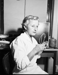 Mrs. Helen Wood, Therapy Technician, with Radiation Protection Device