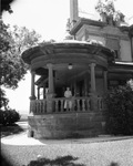 Mrs. F. Hays McFarland stands on the porch of her home at 1110 Penn Street, Fort Worth, Texas