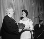 Mrs. Lawrence Tarlton presenting a plaque to Charles H. Fleming