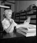 Katie Green Deputy County Clerk, looks over absentee ballot report