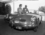 John W. Thornley with wife, director and general manager of the MG Car Co., look over MG.