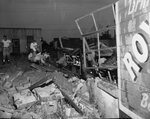 Wreckage of N. Main Auto Supply with unidentified people