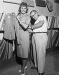 Jack McClure measuring Linda Daugherty, 18, Miss Universe contestant for western outfit