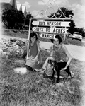 Nan and Susan, right, with sign at entrance of ranch