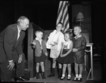 Dirstrict Clerk John Lowther, makes friends with Irish-American children. Pat Tipton, Andrew Tipton, Christina Ford, and Noel Ford. by Wilburn Davis