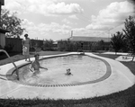 Mrs. Frank L. Sawin leaves her husband with their 3-year-old daughter in their home swimming pool