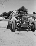Ernie Horn, standing, and Bobby Dodson, check over their entry in drag race a Eagle Mountain Guard Base