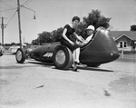 Barbara Mitchum and Don Dodson, admire the dragster which will compete in the Tarrant County Modified Auto Association Drag race
