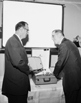 Albert D. White learns about a new Motorola portable stereo phonic hi-fi set from L. O. Braden