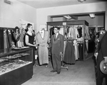 Saul Cohen, store owner and manager, and Mrs. Fay Bell, saleswoman, are in the sports bar of the store's second floor area