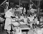 Mrs. Alice Fuller of Texas Power and Light Company demonstrates the use of common small kitchen appliances to Tarrant County 4-H girls by Bud Fichte
