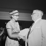 Mrs. Margaret Carter greets a delegate from Precinct 71, J. Carroll McConnell