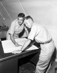 Captain Emmett Rucker Jr. and Captain Robert Peters, Check Their Map of the Flight at a Planning Session