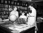 Saleslady Mrs. V. L. Rose Helps Mrs. J. E. Paysinger and Daughter Carol Select Globe