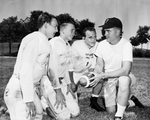 Poly High School football. Larry Griffin, Carl Adams and Billy Telford talk to Coach Tommy Taylor