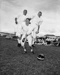 Texas Christian University (TCU) football players. Robert Lilly lifting Harry Moreland and Carlos Vacek