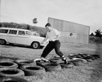 Jim Brock running the obstacle course at Texas Christian University (TCU) by Al Panzera