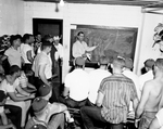 Texas Christian University (TCU) indoor drills. Fred Taylor, Texas Christian University (TCU) freshman coach, holds indoor drills with group of unidentified players by Al Panzera